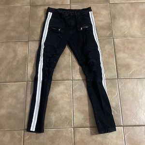 Ripped jeans with zipper pockets and reflective stripes